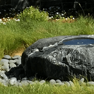 landscape designer grass fountain carved out of natural stone