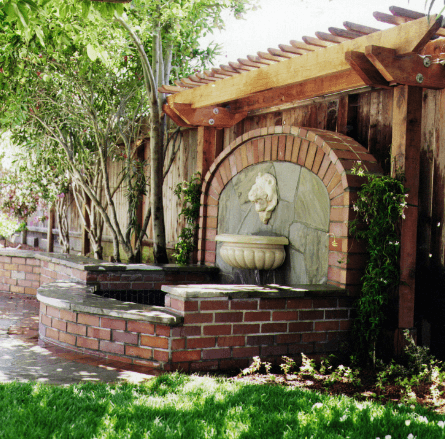 brick foundation patio with lion head water feature