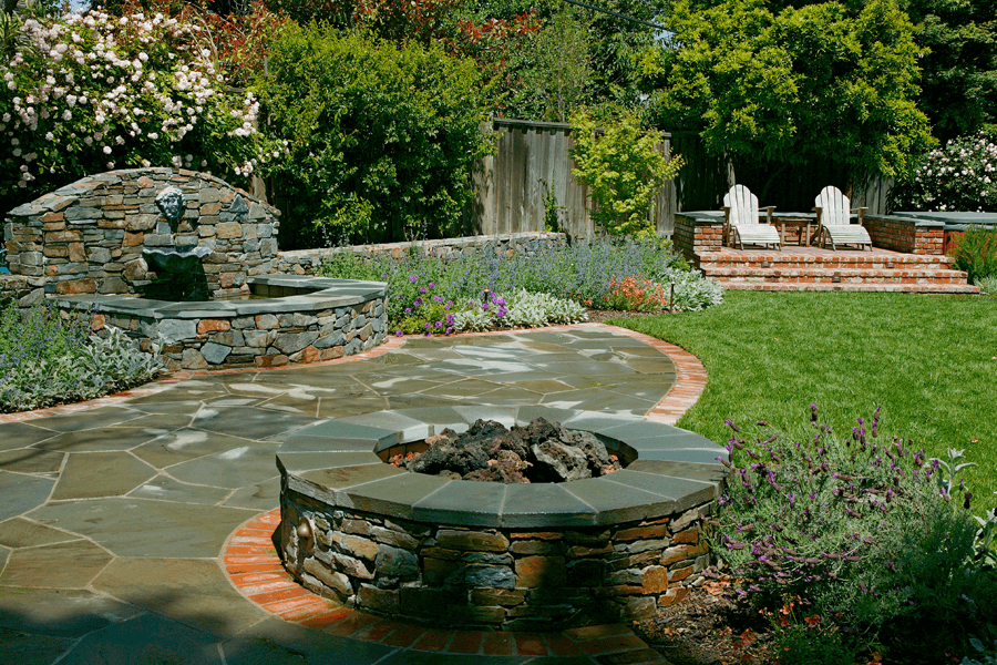 backyard landscape design with firepit and water feature