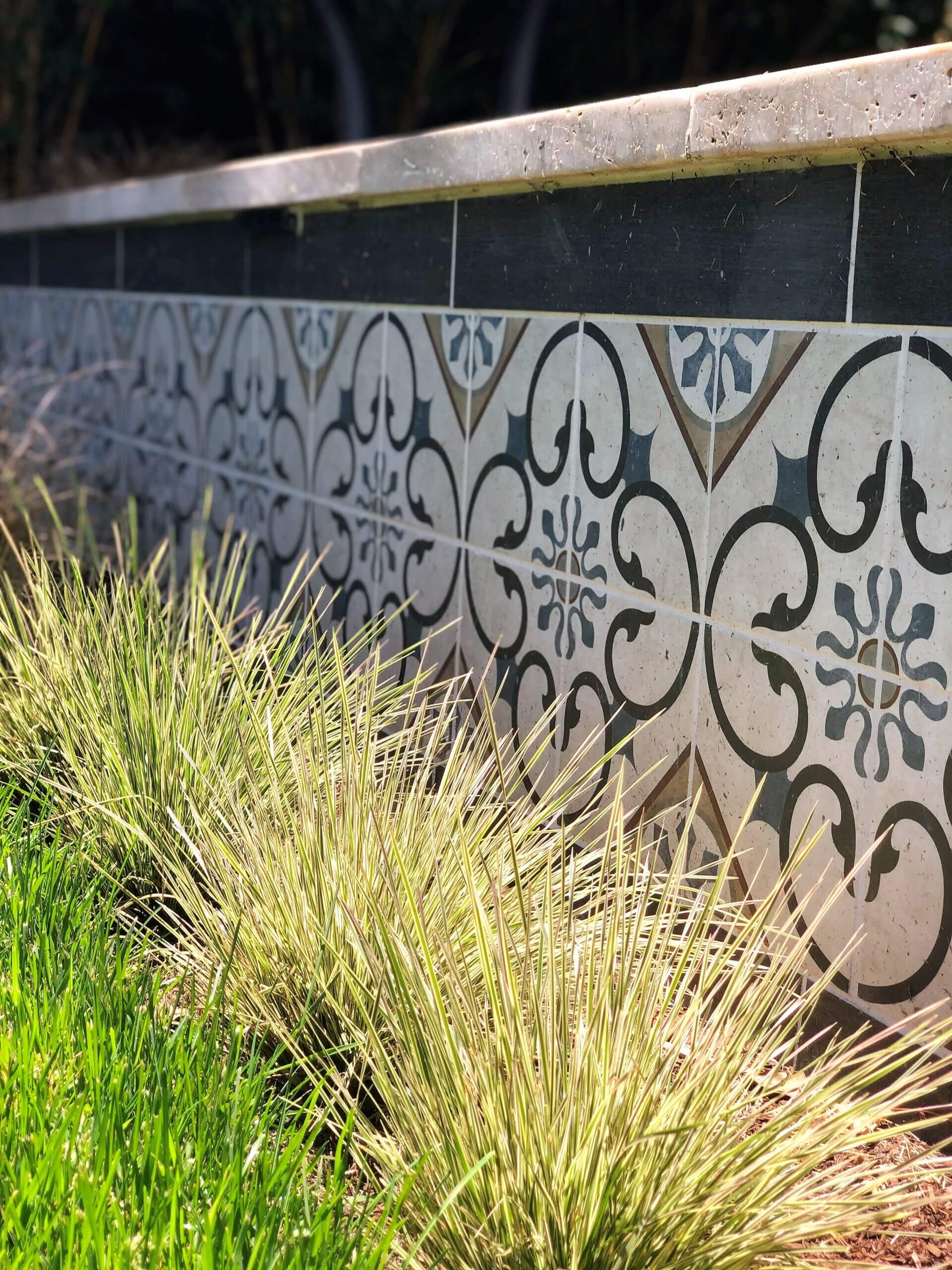Tiled knee wall with ornamental grasses