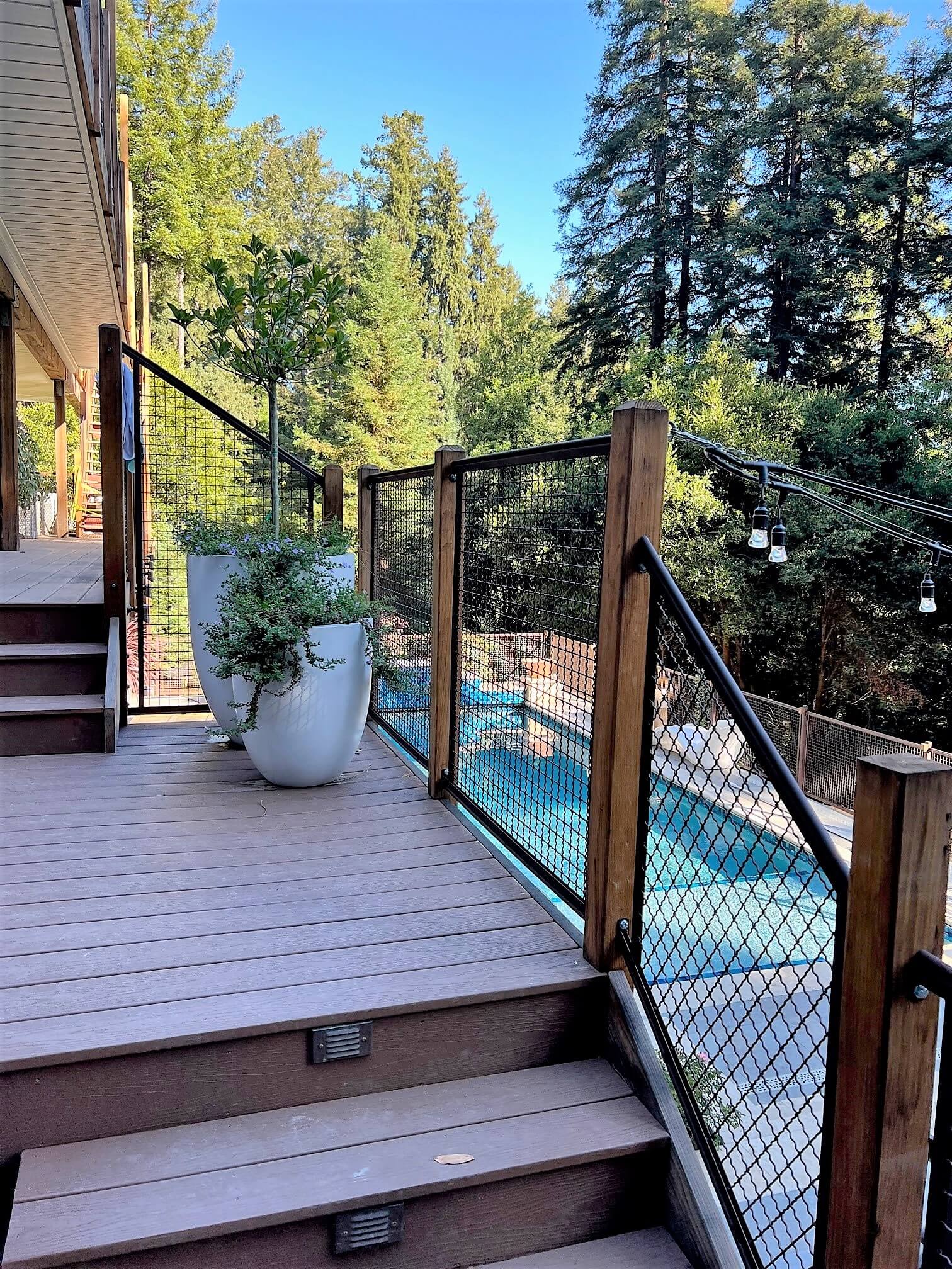 Custom metal and deck railing for deck and balcony overlooking swimming pool