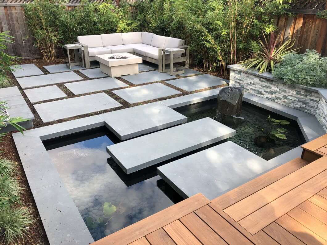 Zen backyard with pedestal stone steps over koi pond