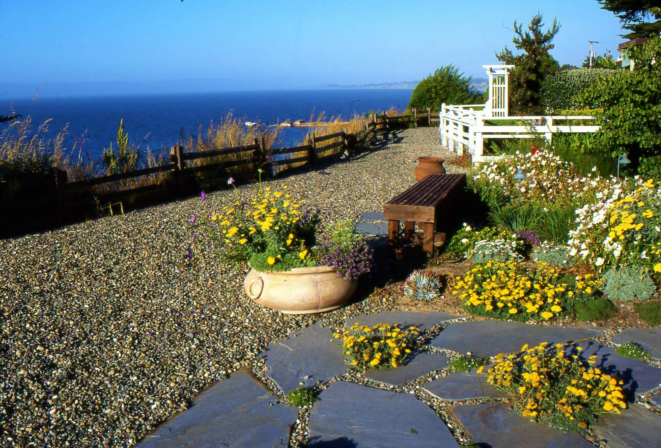 Paver and gravel landscape with wildflowers overlooking the Pacific Ocean