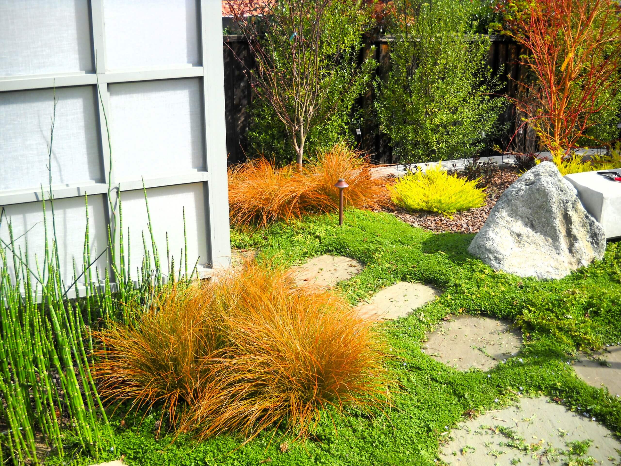 Natural stone pathway in a backyard zen garden with shoji screen