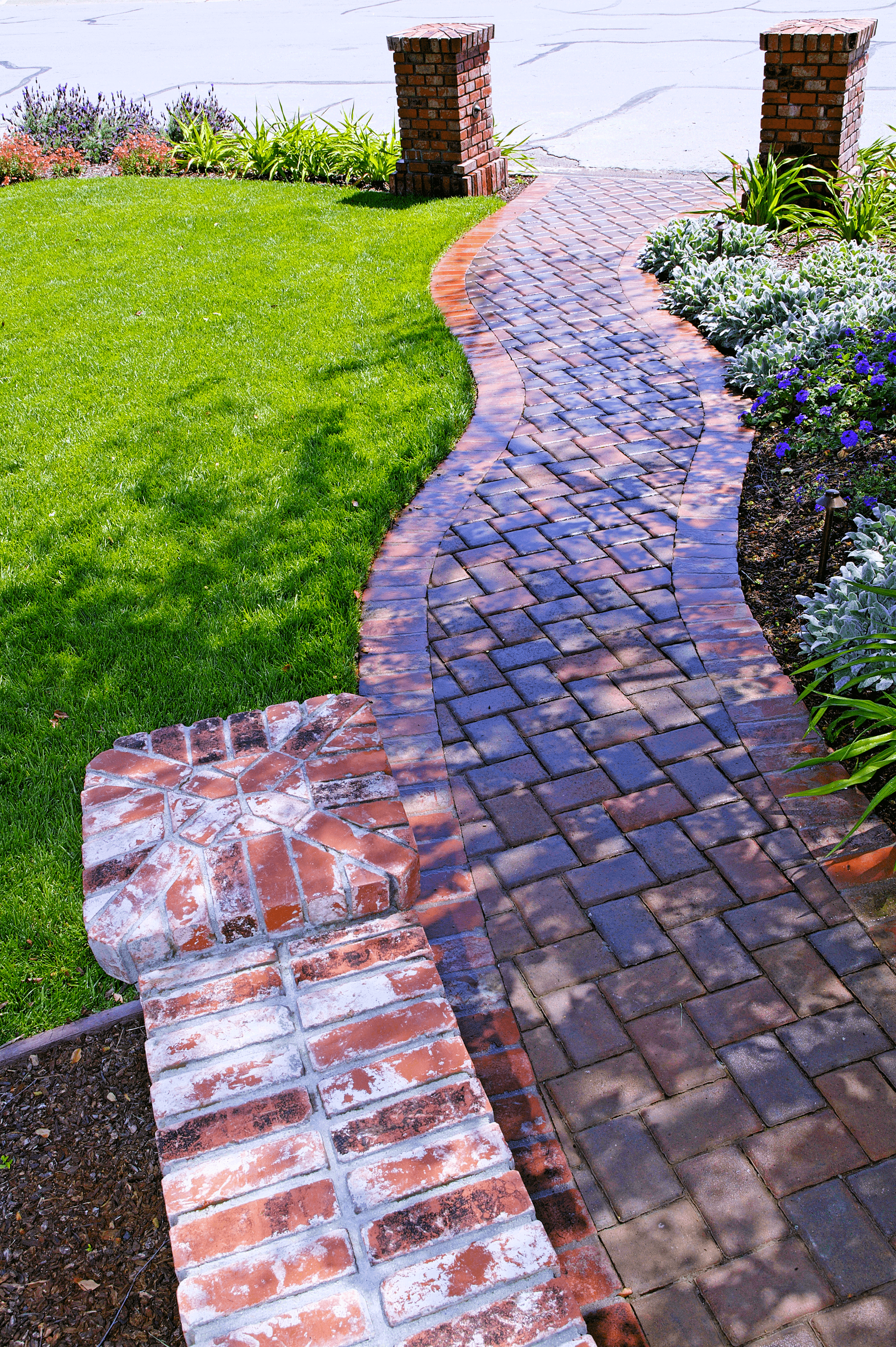 Curved red brick herringbone front yard walkway