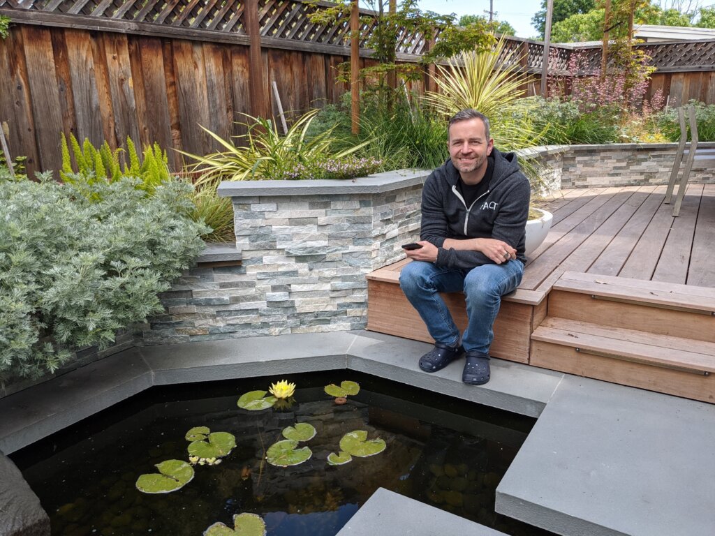 Picture of client relaxing in completed Zen style backyard landscape