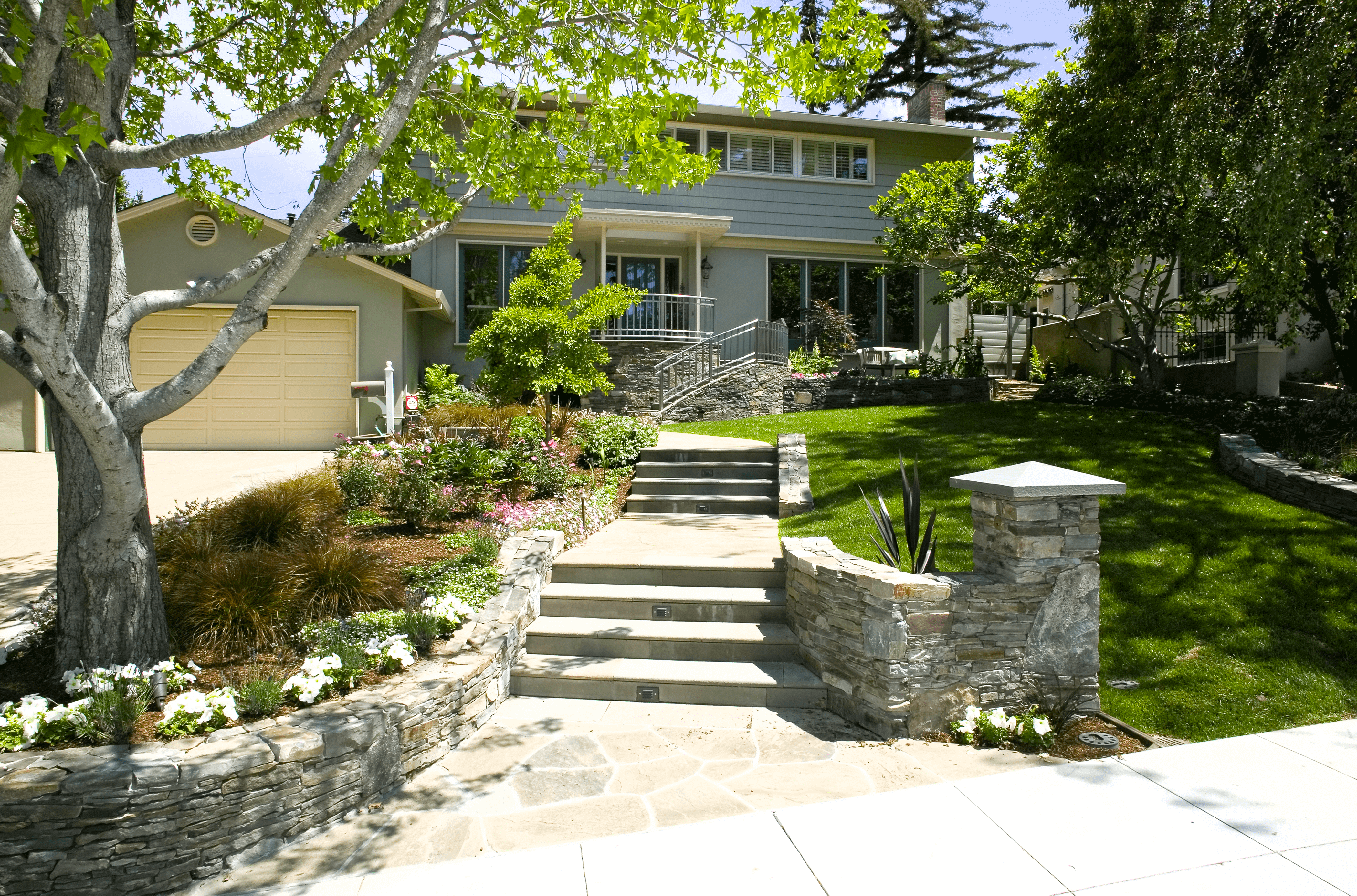 Gorgeous contemporary custom landscaped stone stairs in mid-century home front yard