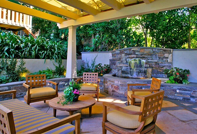 Great outdoor seating area for entertaining and relaxing with the family under pergola on stone patio
