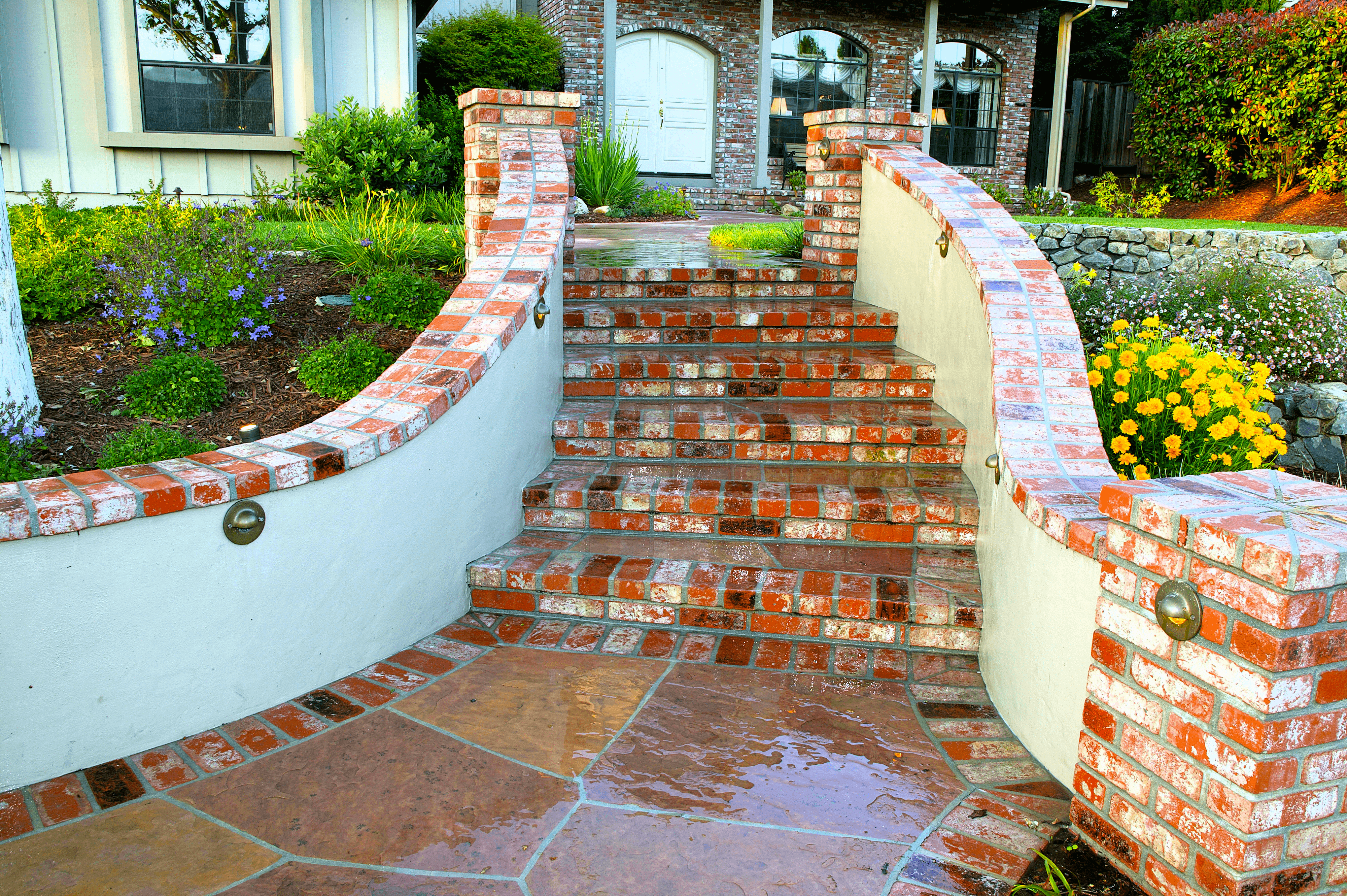 Custom curved brick front steps leading to brick walkway