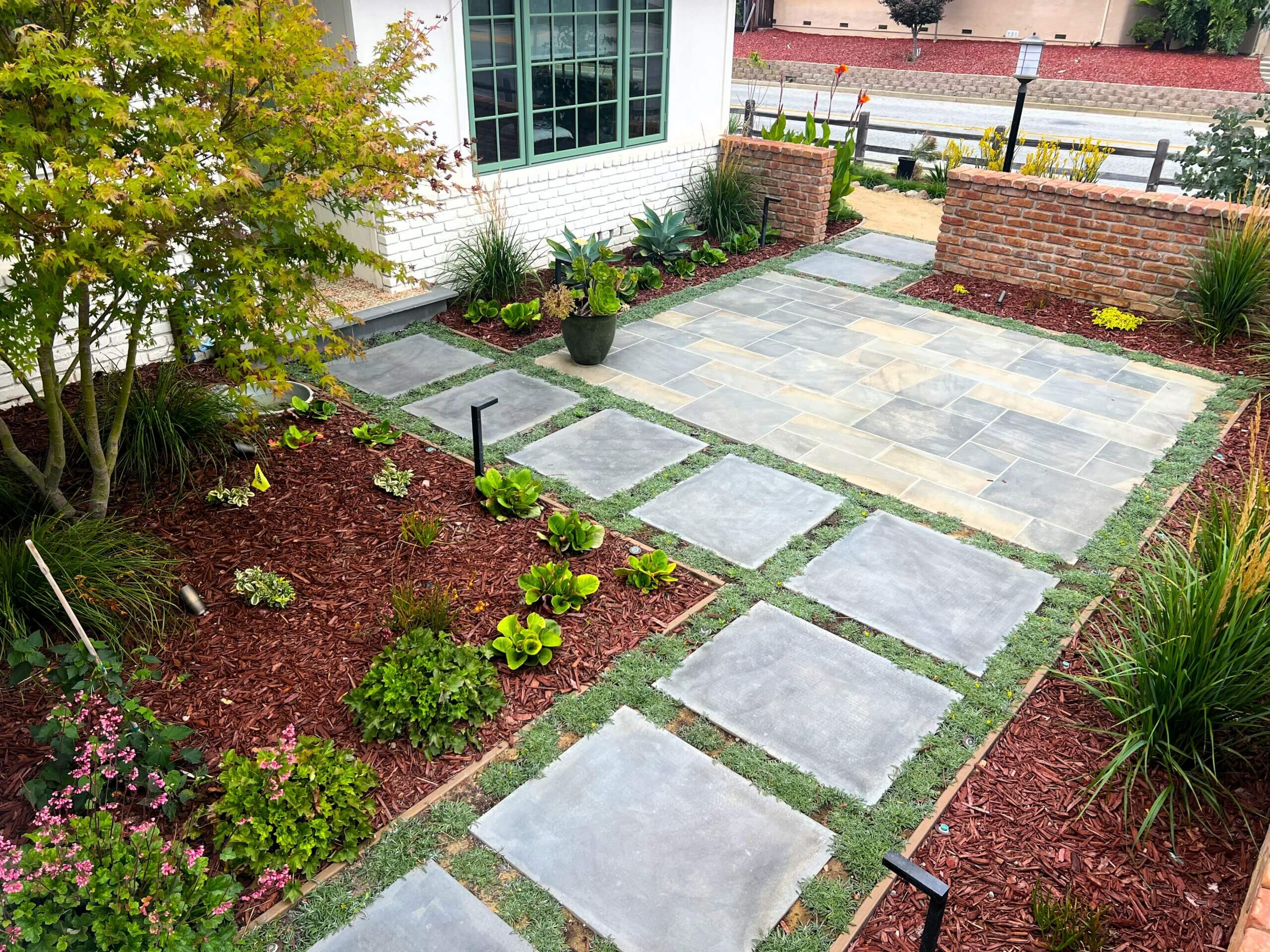 Flagstone patio in front yard entry courtyard with paver stepping stones and low ground cover plantings