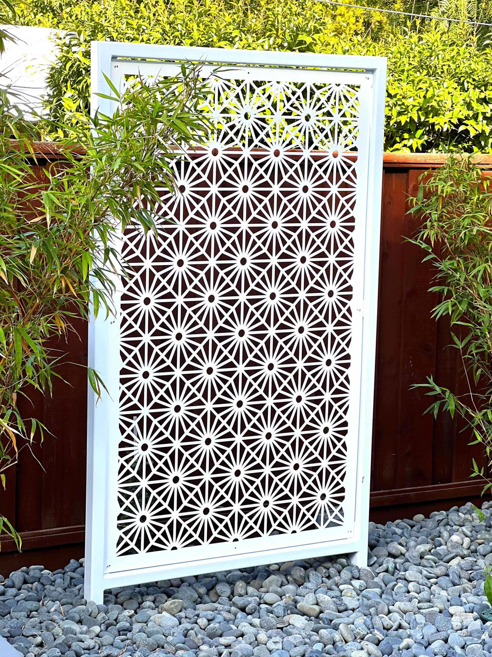 White custom engineered metal backyard screen providing interest in Eichler home landscape remodel